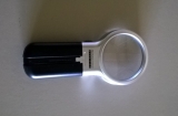 Hand-held folding magnifier with 2 LEDs